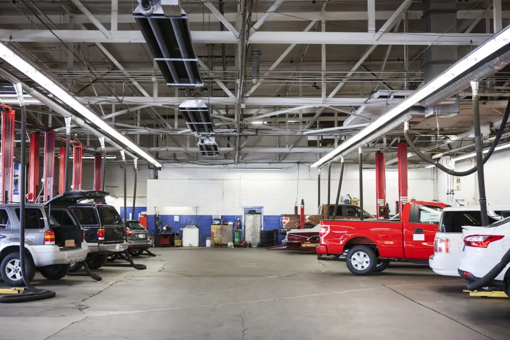 Rows of cars and trucks in auto repair shop